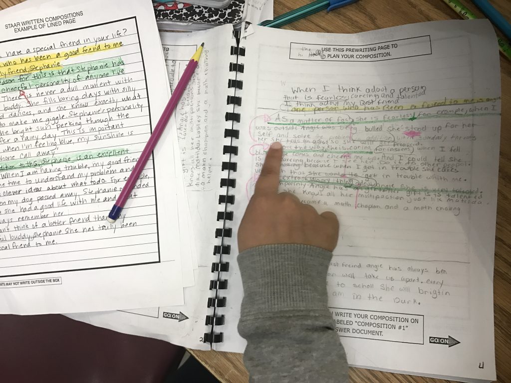 student revising expository writing